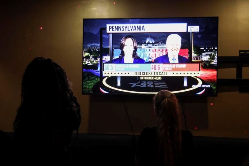 La gente observa cómo se informan los resultados de la votación en las elecciones presidenciales de 2024 por televisión en un bar en Nueva York, Nueva York, EE.UU., el 5 de noviembre de 2024. EFE/SARAH YENESEL 01071124